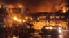 Firefighters and rescue workers gather at the site of a fire at the Grand Diamond City hotel-casino in Poipet, Cambodia, on Dec. 29, 2022. 