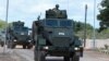 FILe - A Somalia National Army (SNA) soldier rides on an armored personnel carrier during celebrations on their 62nd anniversary in Mogadishu, Apr. 12, 2022. 