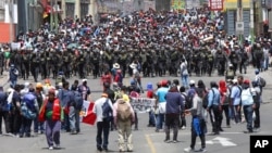 Police arrive where supporters of ousted Peruvian President Pedro Castillo protest his detention in Arequipa, Peru, Dec. 14, 2022. 