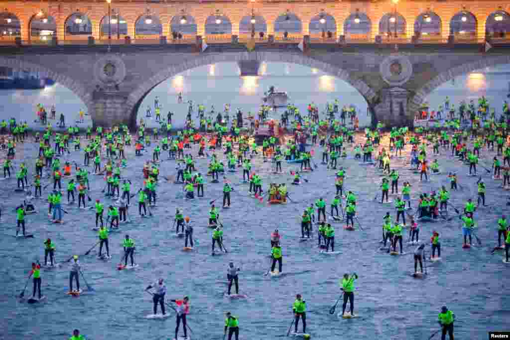 Participants start in the 12th Edition of the Nautic SUP Paris Crossing stand up paddle competition on the river Seine in Paris, France.