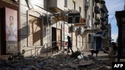 A local resident enters a shop in Bakhmut, Donetsk region, Dec. 2, 2022.