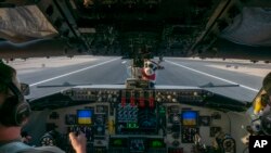 In this handout photo from the U.S. Air Force, pilots from the 340th Expeditionary Air Refueling Squadron land a U.S. Air Force KC-135 Stratotanker at Al-Udeid Air Base, Qatar, Nov. 16, 2022.