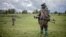 Members of the Patriotic Alliance for a Free and Independent Congo militia patrol during a surveillance tour in Kitshanga, eastern Democratic Republic of the Congo, on Dec. 11, 2022. 
