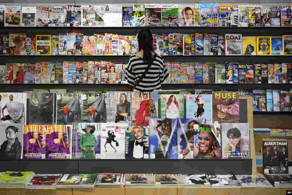 A women reads magazines at a newly-opened bookshop in downtown Kuala Lumpur, Malaysia.