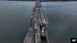 FILE - A general view of the damaged Antonivsky Bridge in Kherson, Ukraine, Nov. 27, 2022.