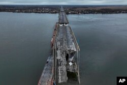 FILE - A general view of the damaged Antonivsky Bridge in Kherson, Ukraine, Nov. 27, 2022.