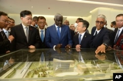 FILE — Chinese Foreign Minister Qin Gang, second left, and African Union Commission chair Moussa Faki Mahamat, center, attend the inauguration of the Africa Centers for Disease Control and Prevention in Addis Ababa, Ethiopia, Jan. 11, 2023.