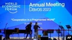 People set up the stage at the eve of the opening of the World Economic Forum in Davos, Switzerland, Jan. 15, 2023. 