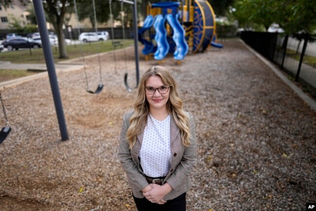 Natalie Rincon poses for a photograph outside a Houston elementary school Thursday, Nov. 17, 2022. (AP Photo/David J. Phillip)