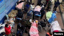 Pasien terbaring di tempat tidur dan tandu di lorong unit gawat darurat di sebuah rumah sakit, di tengah merebaknya COVID-19 di Shanghai, China, 4 Januari 2023.