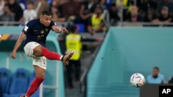 France's Kylian Mbappe shoots the ball during the World Cup group D soccer match between France and Denmark, at the Stadium 974 in Doha, Qatar, Saturday.