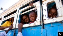 FILE - Refugees who fled the conflict in Ethiopia's Tigray region ride a bus going to the Village 8 temporary shelter, near the Sudan-Ethiopia border, in Hamdayet, eastern Sudan on Dec. 1, 2020.