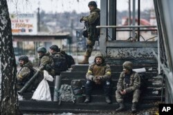 Ukrainian soldiers rest near their position in Bakhmut, Donetsk region, Ukraine, Dec. 17, 2022.