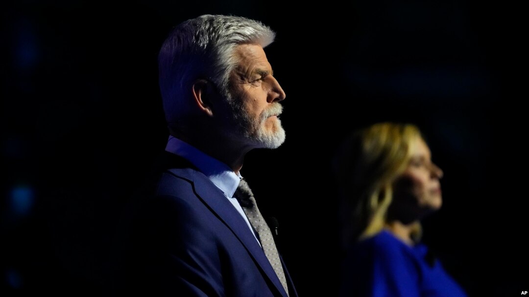 FILE - Presidential candidate Petr Pavel, left, and Danuse Nerudova wait for the start of a political debate at the National Museum in Prague, Czech Republic, Jan. 8, 2023.