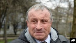 FILE - Mykola Semena speaks outside a court in Simferopol, Crimea, March 20, 2017. 