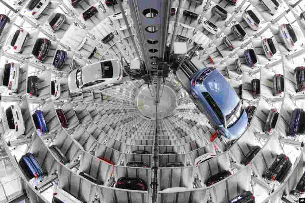 Volkswagen cars are presented to media inside a delivery tower prior to the company&#39;s annual press conference in Wolfburg, Germany.