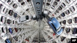 FILE - Volkswagen cars are presented to media inside a delivery tower prior to the company's annual press conference in Wolfburg, Germany, April 28, 2016.