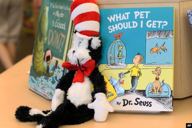 FILE - A plush “Cat in the Hat” toy is displayed next to “What Pet Should I Get?,” the latest book by Dr. Seuss, on Tuesday, July 28, 2015 at a bookstore in Concord, N.H. (AP Photo/Holly Ramer)