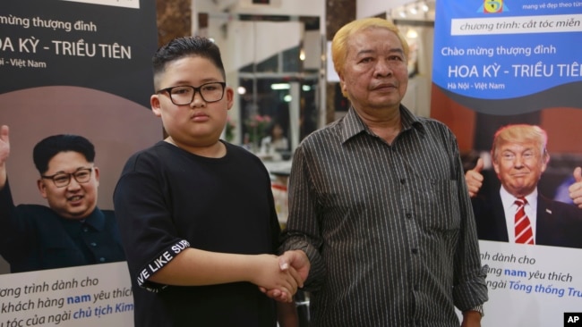 Le Phuc Hai, 66 and To Gia Huy, 9, pose for a photo after having Trump and Kim haircuts in Hanoi, Vietnam, Feb. 19, 2019. U.S. President Donald Trump and North Korean leader Kim Jong Un have become style icons in Hanoi, a week before their second summit there.