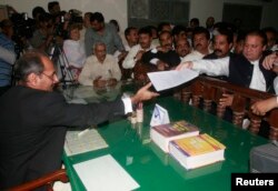 FILE - Former prime minister Nawaz Sharif (R) submits his nomination papers to contest a by-election in Rawalpindi May 12, 2008.