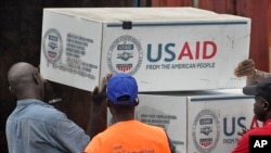 American aid goods are loaded onto a truck after it arrived by airplane, to be used in the fight against the Ebola virus spreading in the city of Monrovia, Liberia, Aug. 24, 2014.