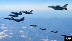 FILE - U.S. and South Korean jets fly over South Korea during a joint military drill called Vigilant Ace, in this handout photo released by the South Korean Defense Ministry, Dec. 6, 2017.