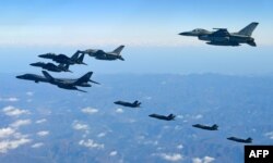 FILE - U.S. and South Korean jets fly over South Korea during a joint military drill called Vigilant Ace, in this handout photo released by the South Korean Defense Ministry, Dec. 6, 2017.