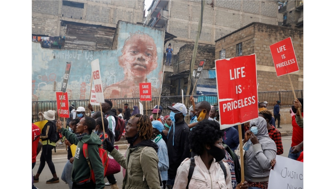 Protesters hold placards during a demonstration against police killings and brutality, in the Mathare slum in Nairobi, Kenya, June 8, 2020.