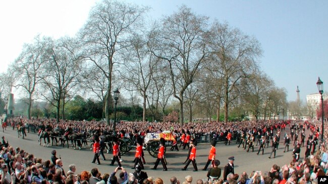 FILE - The gun carriage carrying the coffin of Britain's Queen Mother, is pulled by the Royal Horse Artillery, with members of the royal family following as it enters Horse Guards Parade on its journey to Westminster Hall, in London, Friday April 5, 2002.