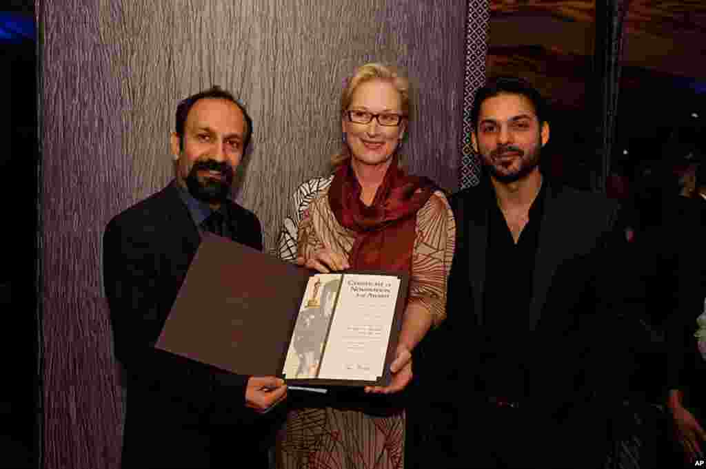 .Asghar Farhadi, " Separation" (left), accepts his certificate of nomination for the 84th Academy Awards from Meryl Streep (center) with actor Peyman Moadi (right)at a Foreign Language Film Award reception held in the Grand Lobby of the Samuel Goldwyn The