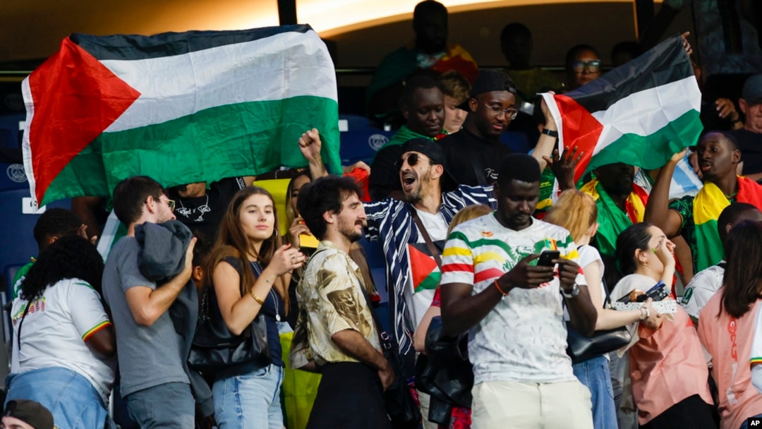 FILE - Spectators hold Palestinian flags as they watch the men's group D match between Israel and Mali at the Parc des Princes during the 2024 Summer Olympics, July 24, 2024, in Paris, France.