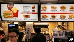 McDonald's Hong Kong restaurants have taken chicken nuggets and chicken filet burgers off the menu following accusations of selling expired meat. A menu as of July 25, 2014.