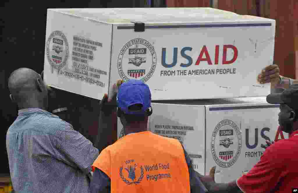 American Aid goods are loaded onto a truck after arriving by airplane, to be used in the fight against the Ebola virus spreading in the city of Monrovia, Liberia, Aug. 24, 2014.