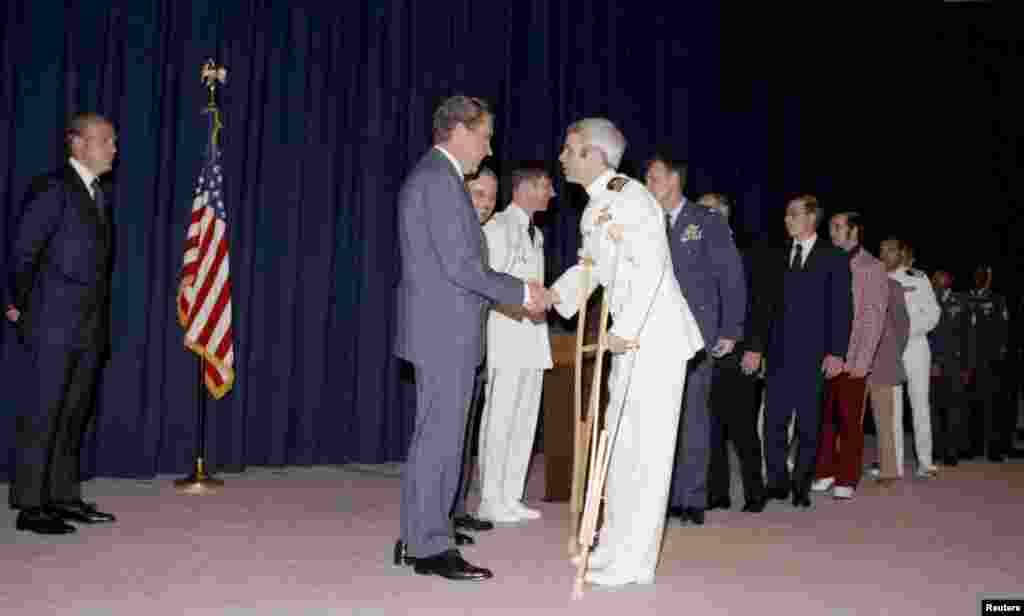 U.S. President Richard Nixon greets former Vietnam prisoner of war John McCain at a pre-POW dinner reception in Washington, May 24, 1973. 