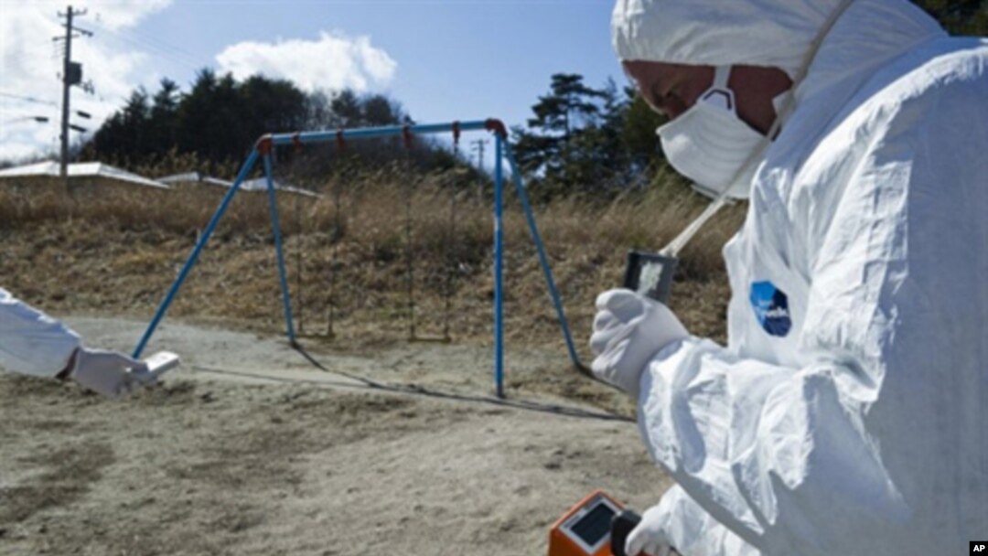 A handout picture released by Greenpeace and taken on March 27, 2011 shows Greenpeace members monitoring contamination levels at Iitate village, 40 km northwest of the crisis-stricken Fukushima nuclear plant, and 20 km beyond the official evacuation zone.