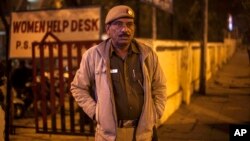 An Indian policeman stands outside the police station which is investigating the gang-rape of a Danish tourist in New Delhi, India, Jan. 15, 2014. 