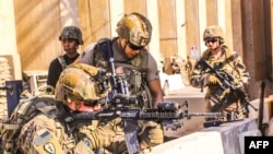 A picture received from the U.S. embassy in Iraq on Dec. 31, 2019, shows U.S. soldiers taking position in Baghdad. Two American servicemembers were killed March 11, 2020, by a rocket attack on Camp Taji, north of the capital.