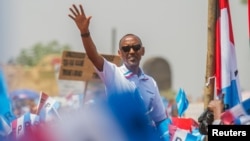 Rwandan President Paul Kagame of the ruling Rwandan Patriotic Front (RPF) waves to his supporters during his final campaign rally in Kigali, Rwanda, Aug. 2, 2017.