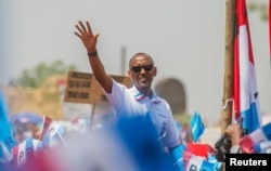 FILE - Rwandan President Paul Kagame of the ruling Rwandan Patriotic Front (RPF) waves to his supporters during his final campaign rally in Kigali, Rwanda, Aug. 2, 2017.