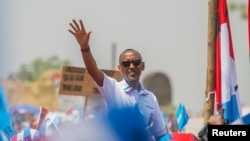 FILE - Rwandan President Paul Kagame of the ruling Rwandan Patriotic Front (RPF) waves to his supporters during his final campaign rally in Kigali, Rwanda, Aug. 2, 2017.
