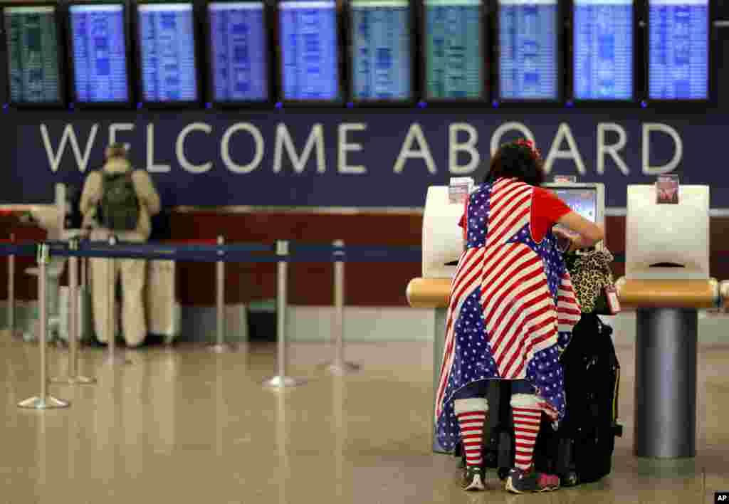 Judy Izzie, dressed in the theme of the American flag, checks in for her flight at Hartsfield-Jackson Atlanta International Airport ahead of the Thanksgiving holiday in Atlanta, Georgia.