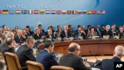 FILE - NATO defense ministers are seated during a meeting of the North Atlantic Council Defense Ministers session at NATO headquarters in Brussels, Oct. 27, 2016. On Tuesday they will face a busy agenda as they meet for year-end talks.