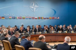 FILE - NATO defense ministers are seated during a meeting of the North Atlantic Council Defense Ministers session at NATO headquarters in Brussels, Oct. 27, 2016.