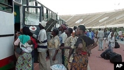 Part of millions of frightened immigrants, some Burkina Faso citizens unload their belongings at the national soccer stadium in Ouagadougou, Burkina Faso after they came home from the cocoa plantations and coffee fields of neighboring Ivory Coast (File Ph