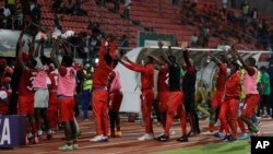 Malawi's soccer players and team officials celebrate after the African Cup of Nations 2022 group B soccer match between Malawi and Zimbabwe at the Omnisport Stadium in Bafoussam, Cameroon, Friday, Jan. 14, 2022. (AP Photo/Sunday Alamba)