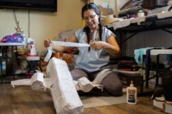 In this photo provided by Alaska Public Media, Carolina Tolladay Vadal is shown making a piñata in her home in Anchorage, Alaska, on April 14, 2021