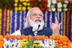 Prime Minister Narendra Modi speaks during a ceremony in Kutch district in western India, Dec. 15, 2020, in this handout photograph released by the Indian Press Information Bureau.