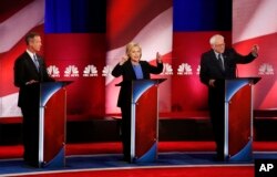 From left, Democratic presidential candidates former Maryland Gov. Martin O'Malley, former Secretary of State Hillary Clinton and Senator Bernie Sanders participate in the NBC, YouTube debate at the Gaillard Center, in Charleston, S.C., Jan. 17, 2016.
