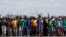 Mine workers protest outside the Lonmin mine in Rustenburg, northwest of Johannesburg, Jan. 23, 2014. 
