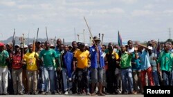 Mine workers protest outside the Lonmin mine in Rustenburg, northwest of Johannesburg, Jan. 23, 2014. 